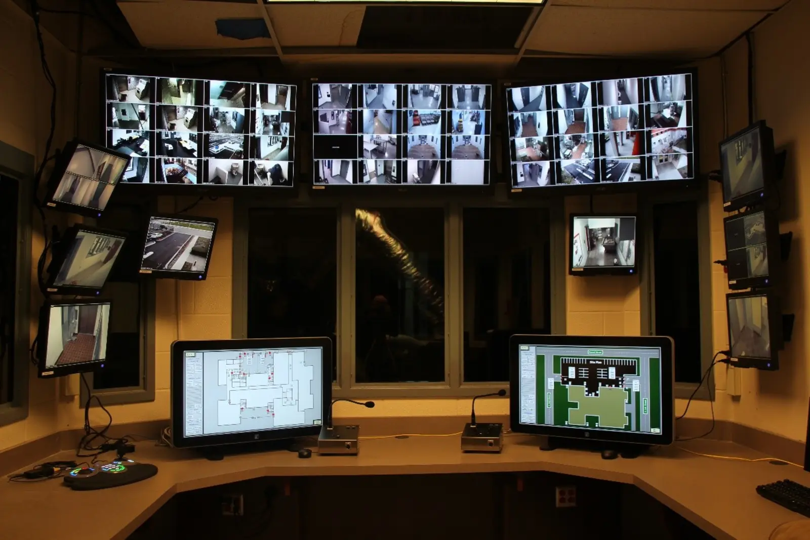 Control room with camera monitors and touch screen stations